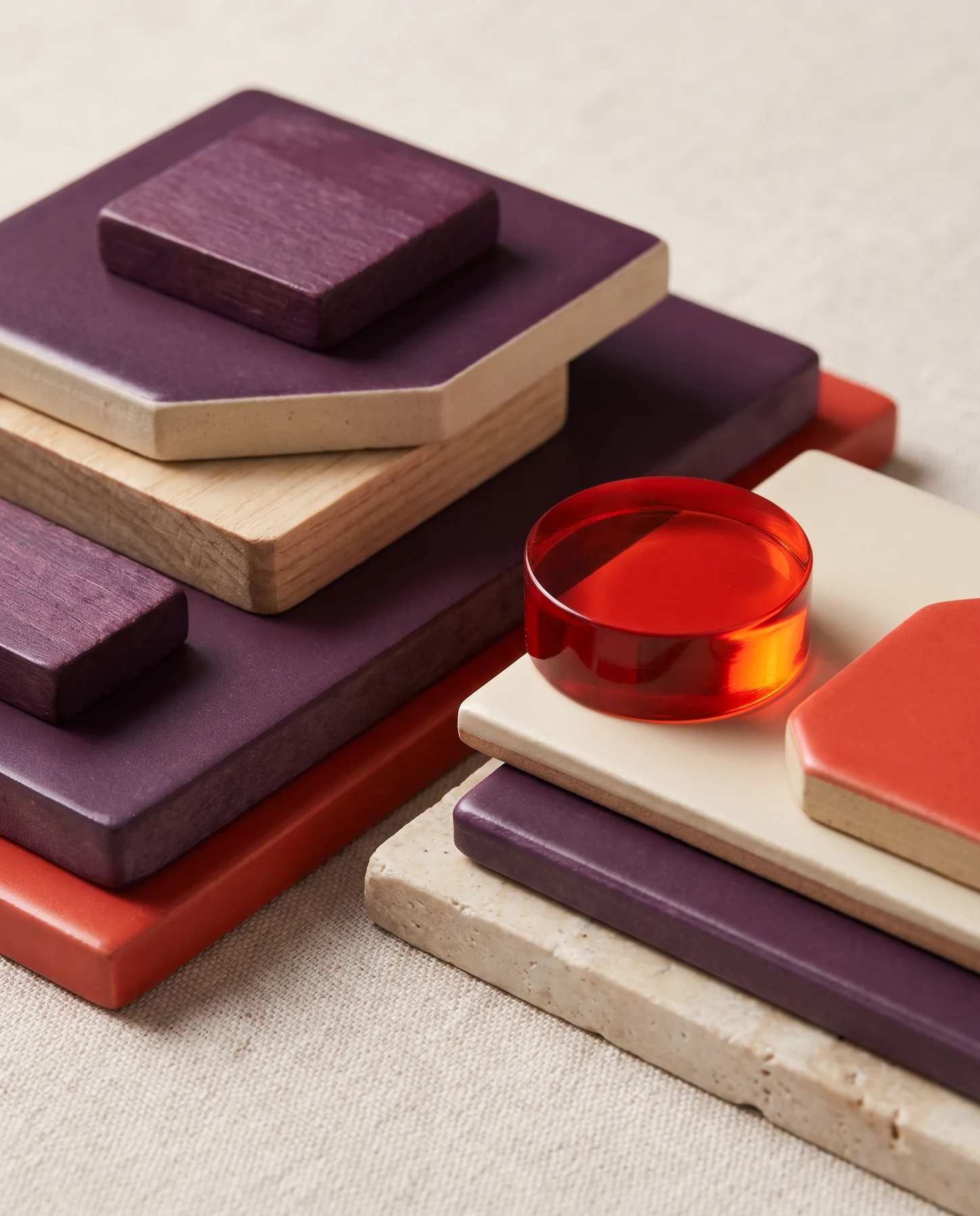 A stack of purple, cream, and red game components